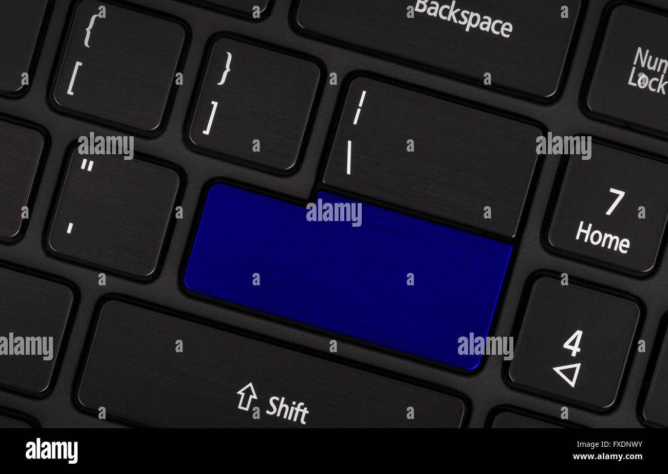 Laptop computer keyboard with blank blue button for text Stock Photo