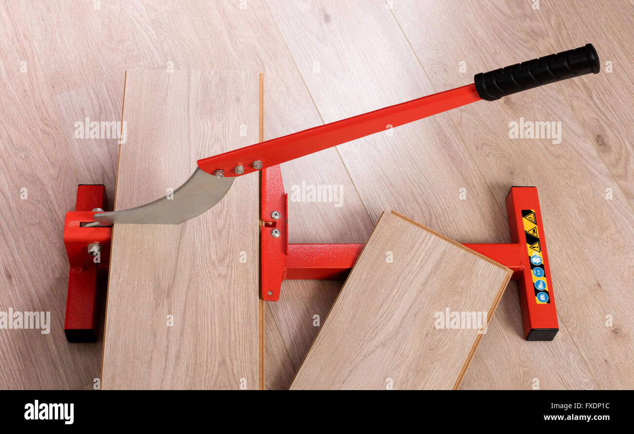 Red Tool For Cutting Laminate On A Laminate Floor Stock Photo