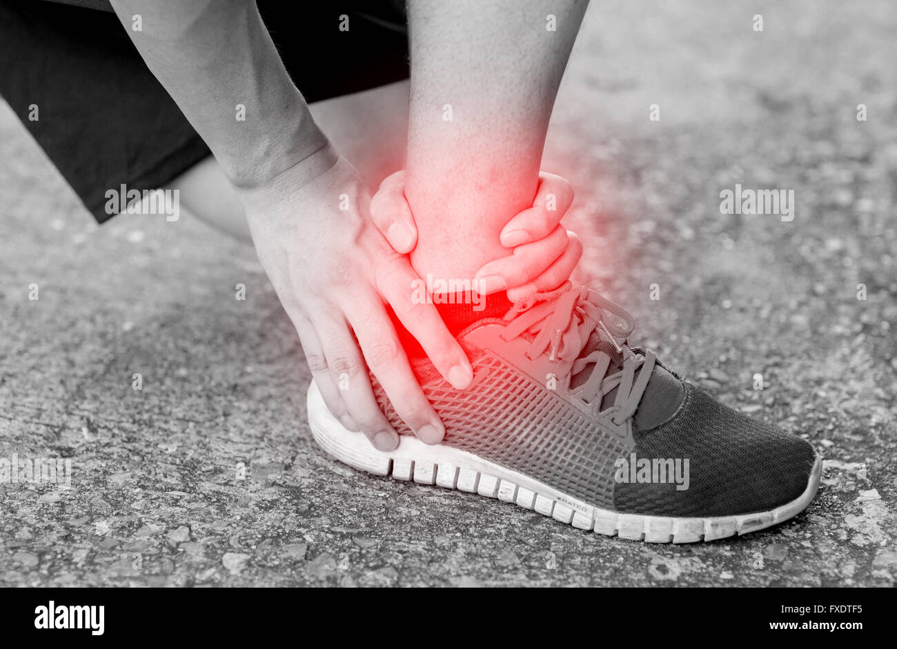 Runner touching painful twisted or broken ankle. Athlete runner