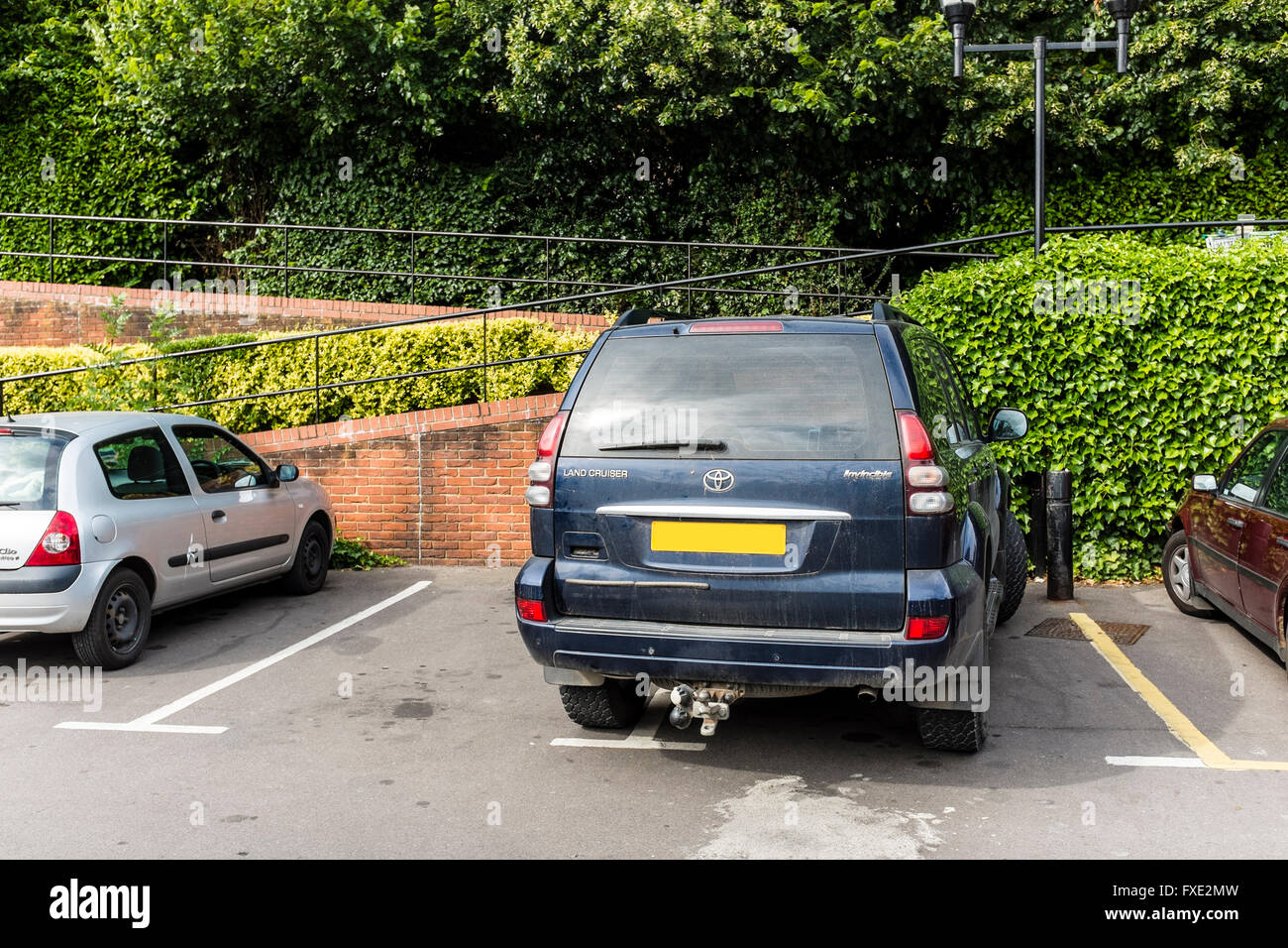 Inconsiderate parking in a car park, UK Stock Photo