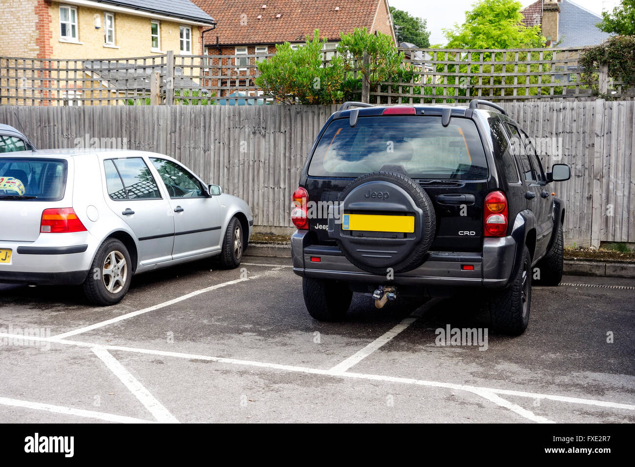Inconsiderate parking in a car park, UK Stock Photo