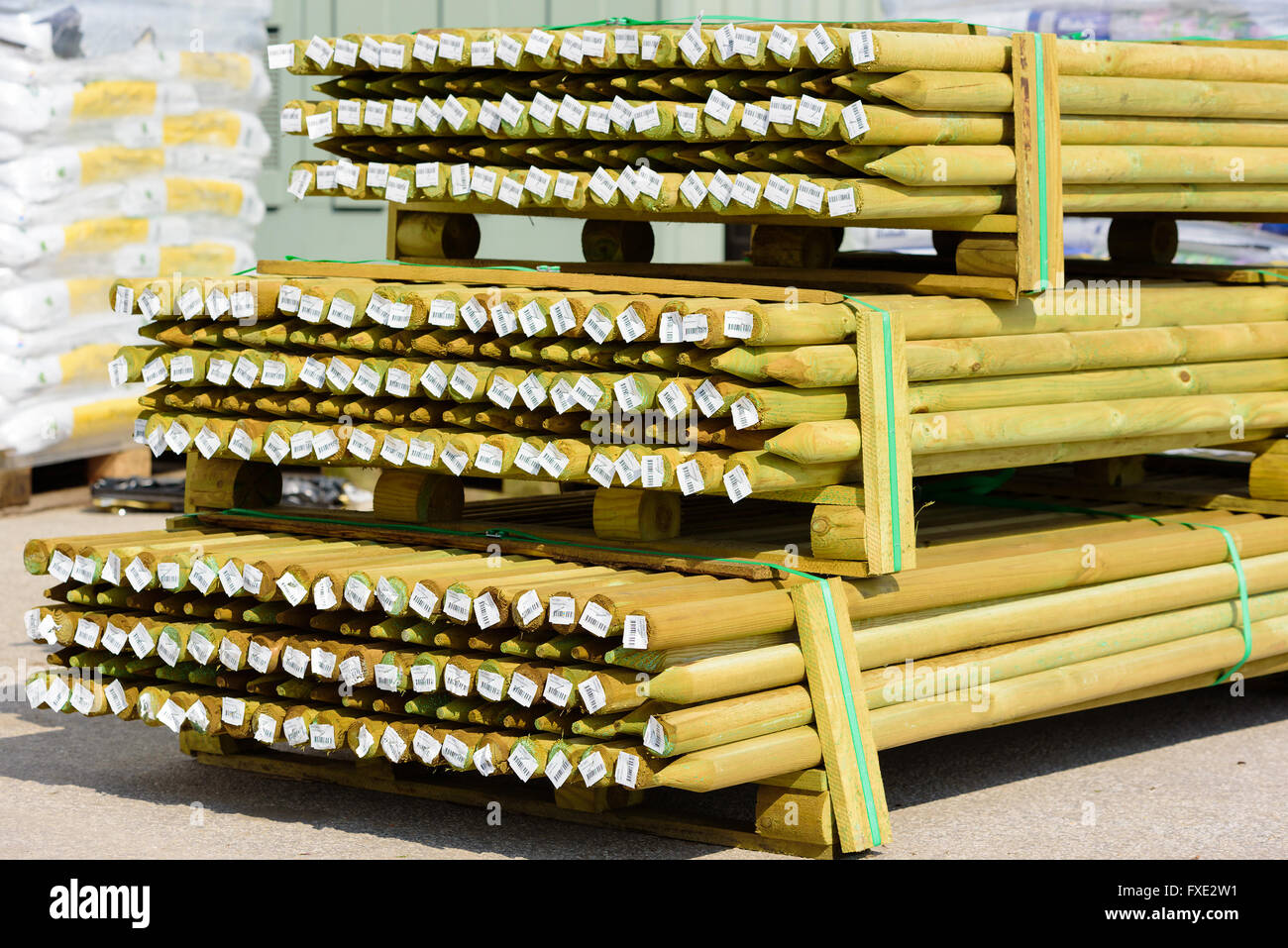Lyckeby, Sweden - April 7, 2016: Stack of green pressure impregnated wooden poles with barcode price tags at the ends, at a publ Stock Photo