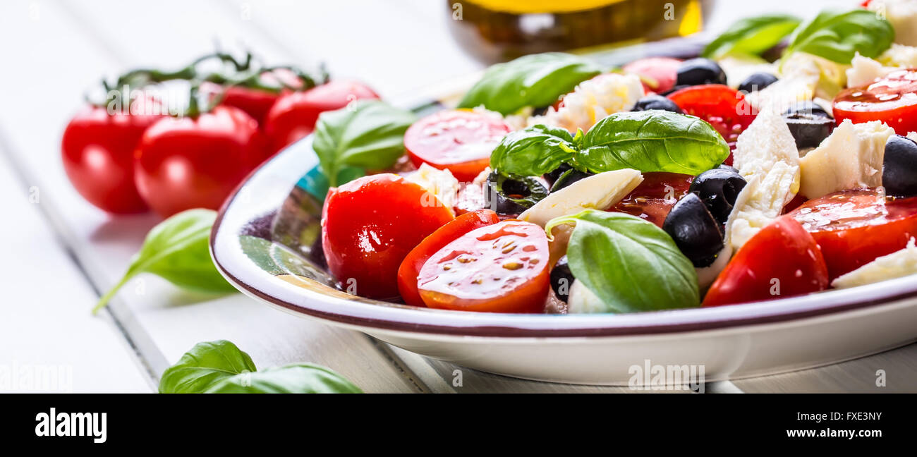 Caprese. Caprese salad. Italian salad. Mediterranean salad. Italian cuisine. Mediterranean cuisine. Tomato mozzarella basil leav Stock Photo