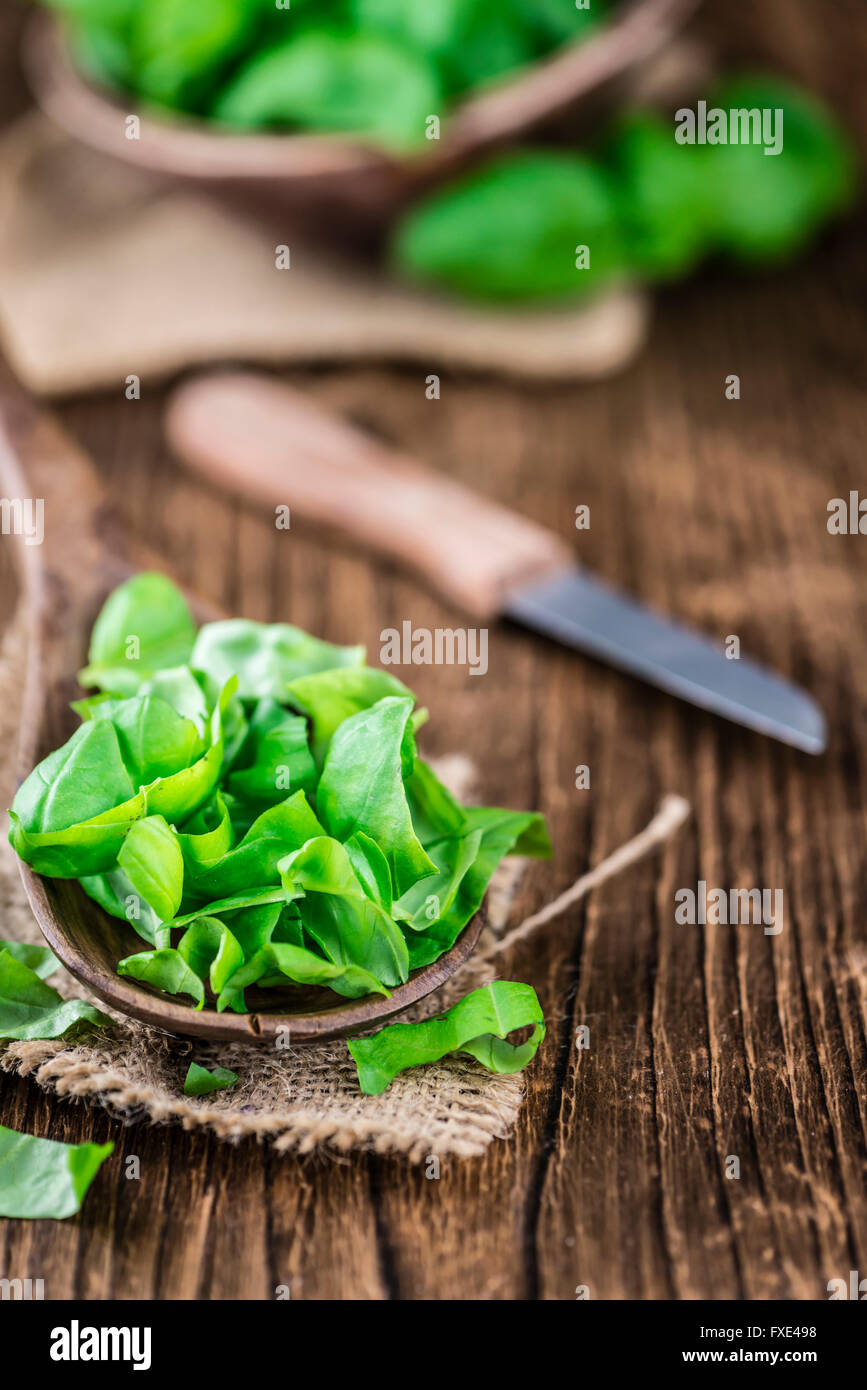 Portion of fresh Basil (close-up shot; selective focus) on wooden background Stock Photo