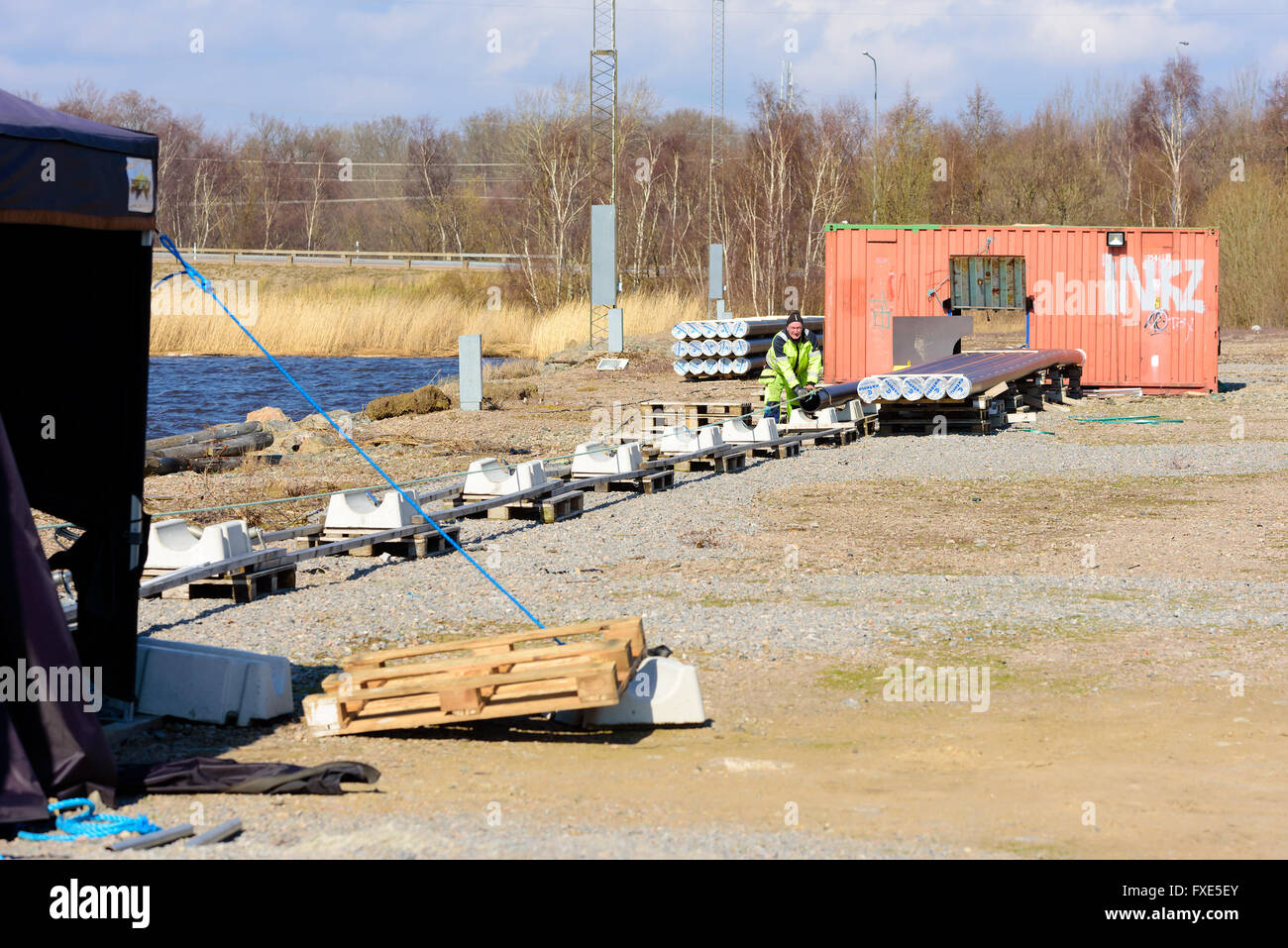 Karlskrona, Sweden - April 7, 2016: Assembly of underwater sewage pipeline in public area. Here a man is mounting a line to the Stock Photo