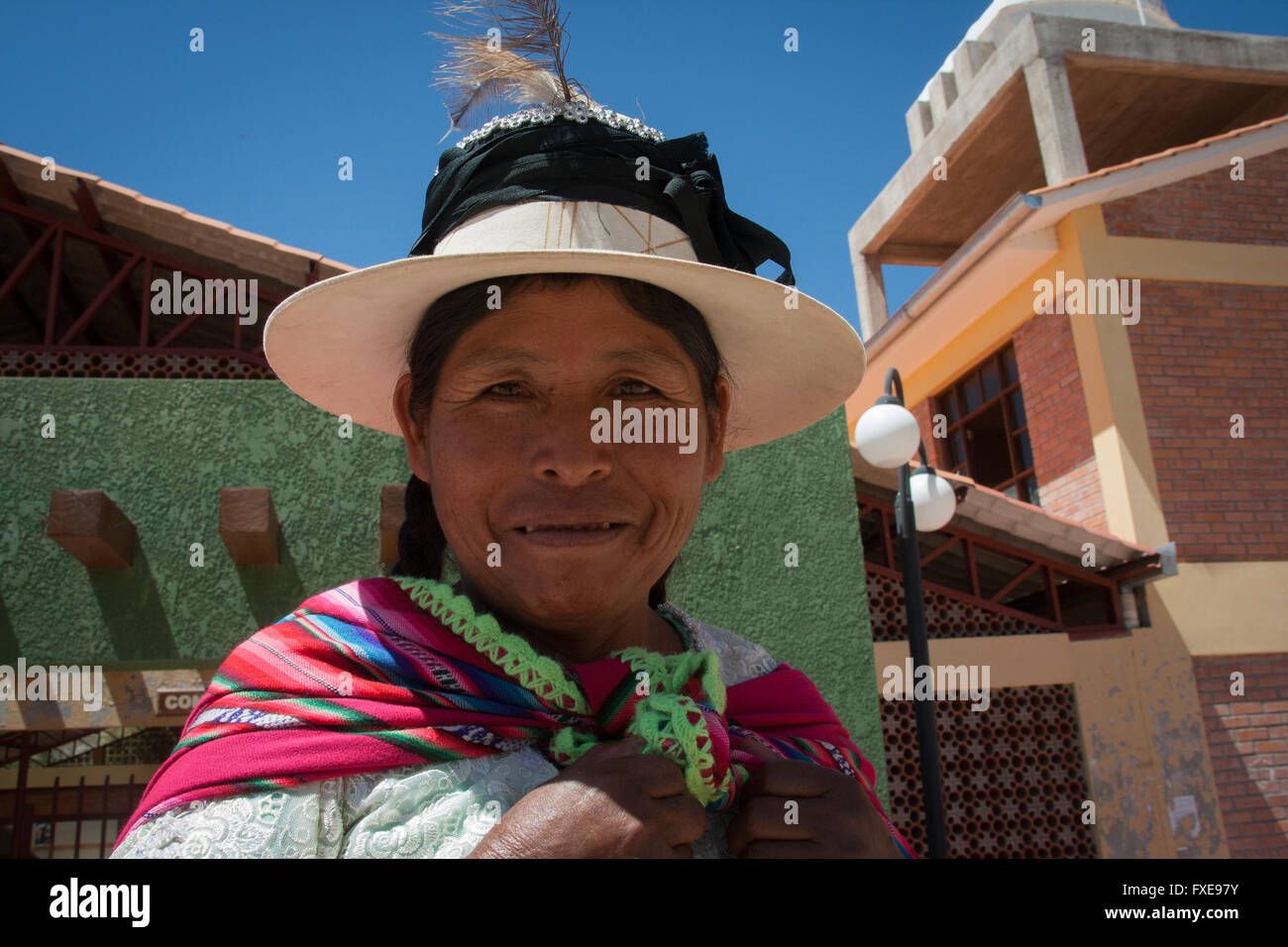 Bolivia, a portrait of a smiling woman outside in front of her house. Stock Photo