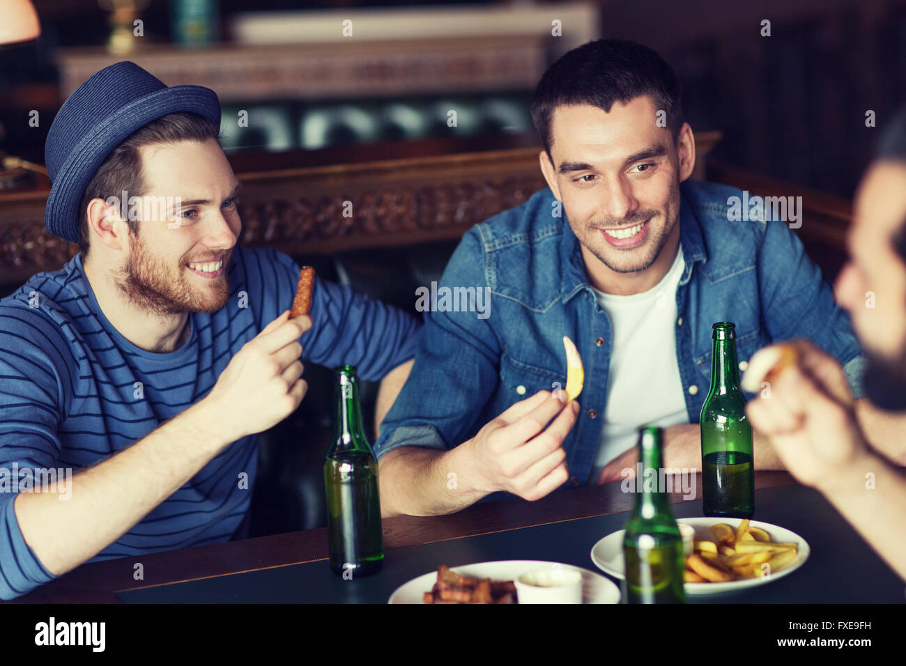 happy male friends drinking beer at bar or pub Stock Photo