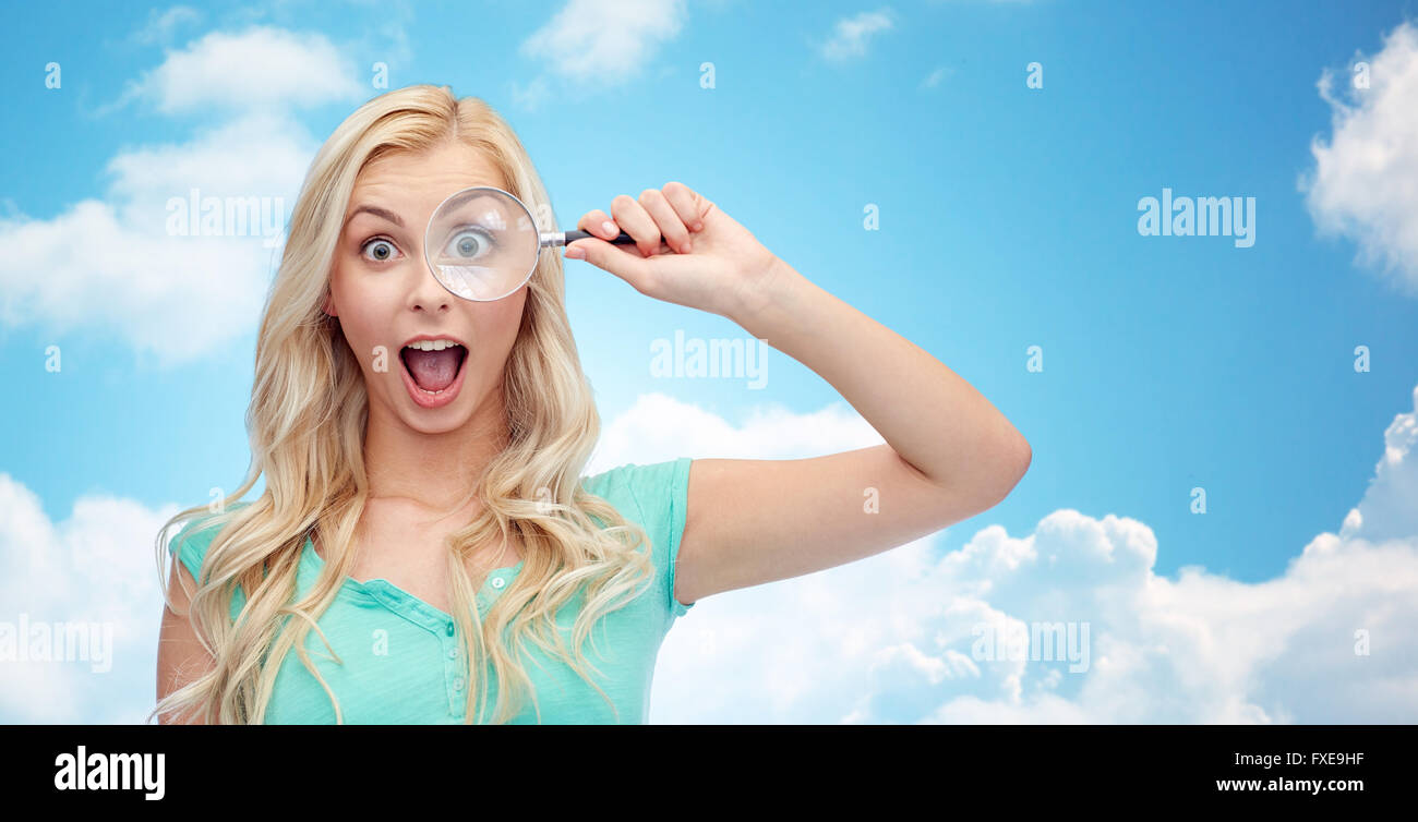 happy young woman with magnifying glass Stock Photo