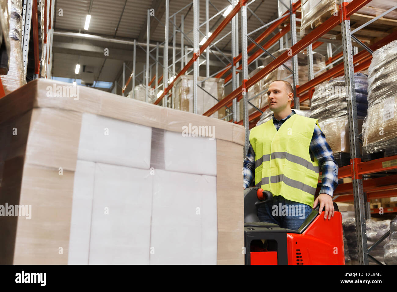 man with tablet pc operating forklift at warehouse Stock Photo