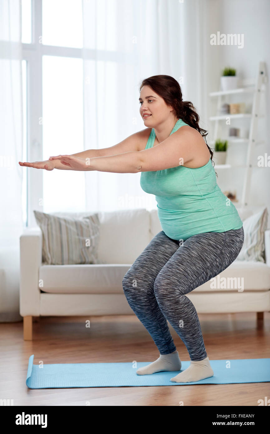 plus size woman exercising on mat at home Stock Photo - Alamy