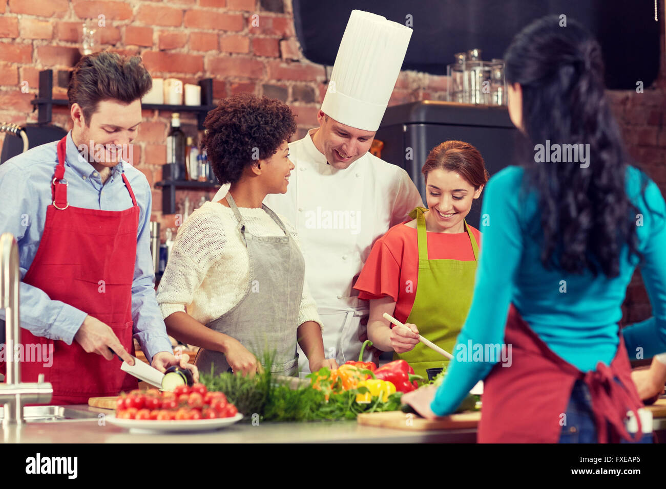 happy friends and chef cook cooking in kitchen Stock Photo - Alamy