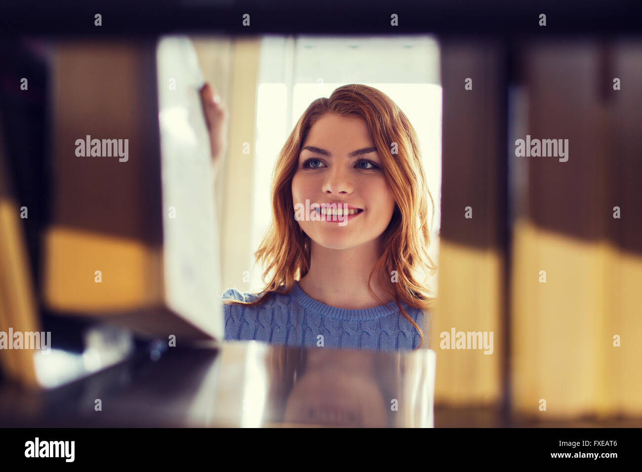happy student girl or woman with book in library Stock Photo - Alamy
