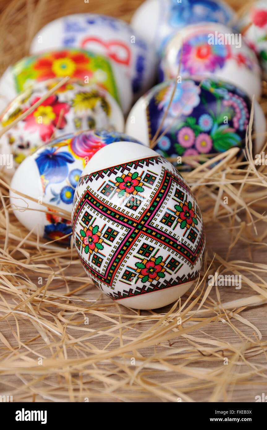 A variety of painted Easter eggs on the table in the hay Stock Photo ...
