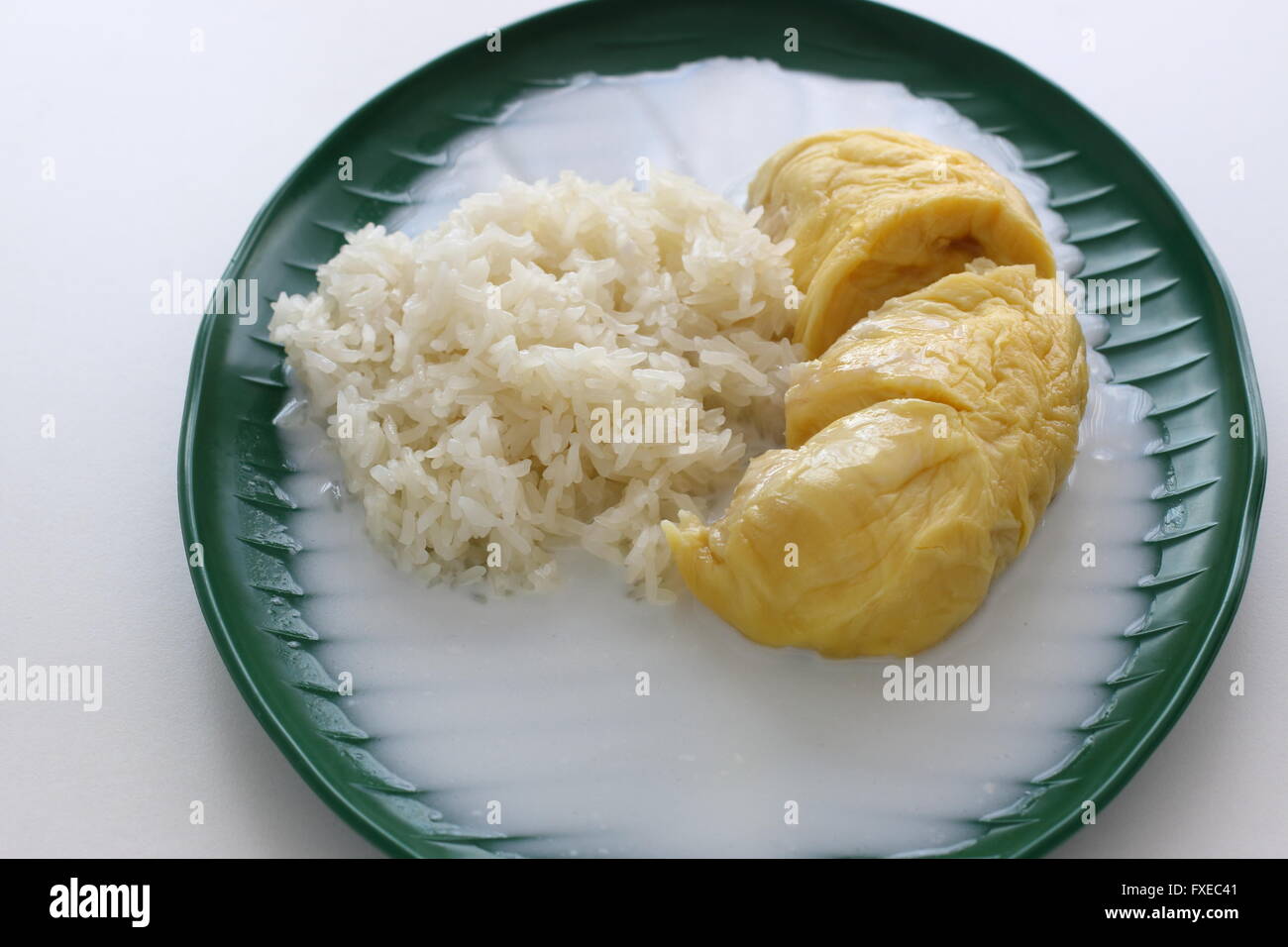 Close up image of Sweet  Glutinous Sticky Rice With Durian And Coconut Milk Sauce Stock Photo