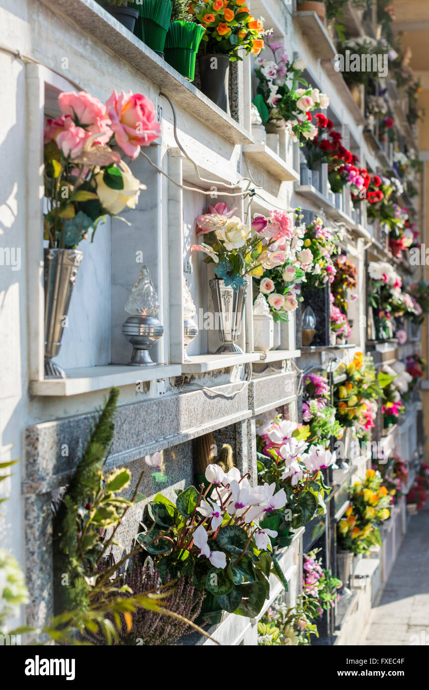 Flowers on graveyard tombstones Stock Photo