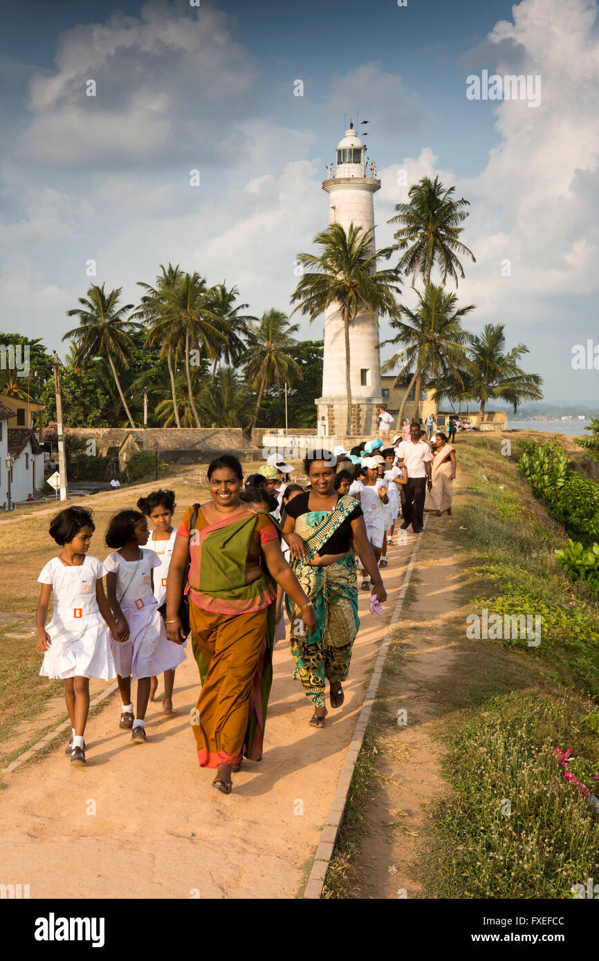 Sri Lanka, Galle Fort, lighthouse, school party walking on historic old walls Stock Photo