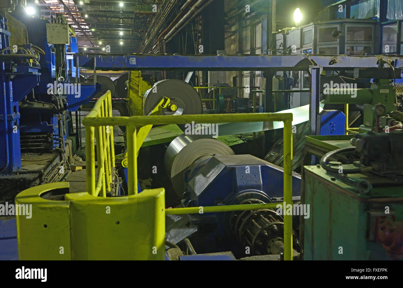 machine for rolling steel coil in warehouse Stock Photo
