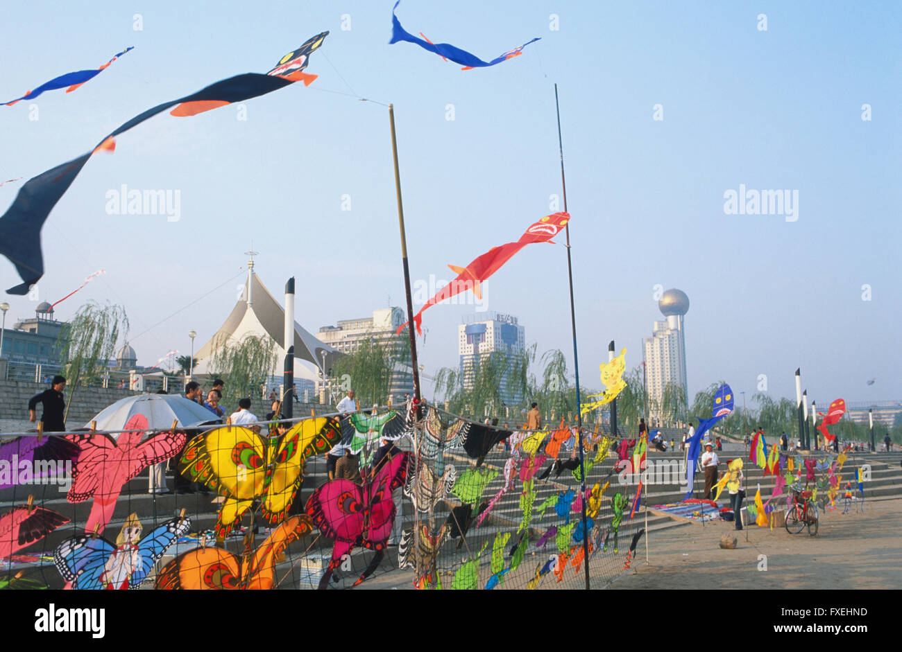 China, Hubei, Wuhan, Yangzi riverfront, colourful kites for sale blowing in the wind. Stock Photo
