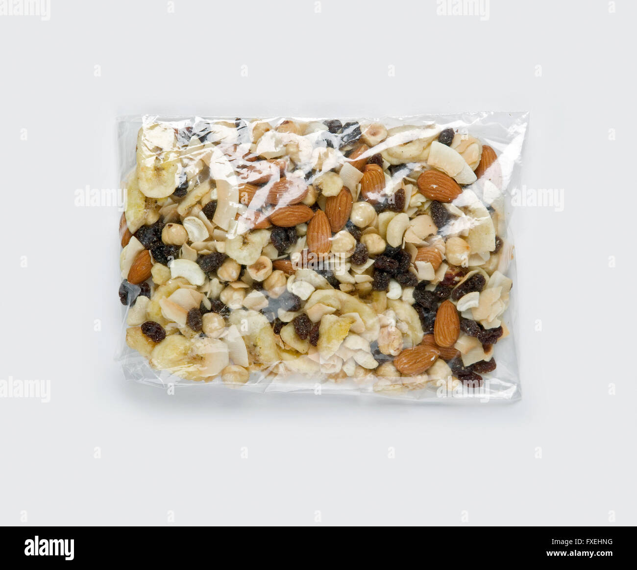 Assorted nuts and dried fruits in clear plastic bag, close-up Stock Photo