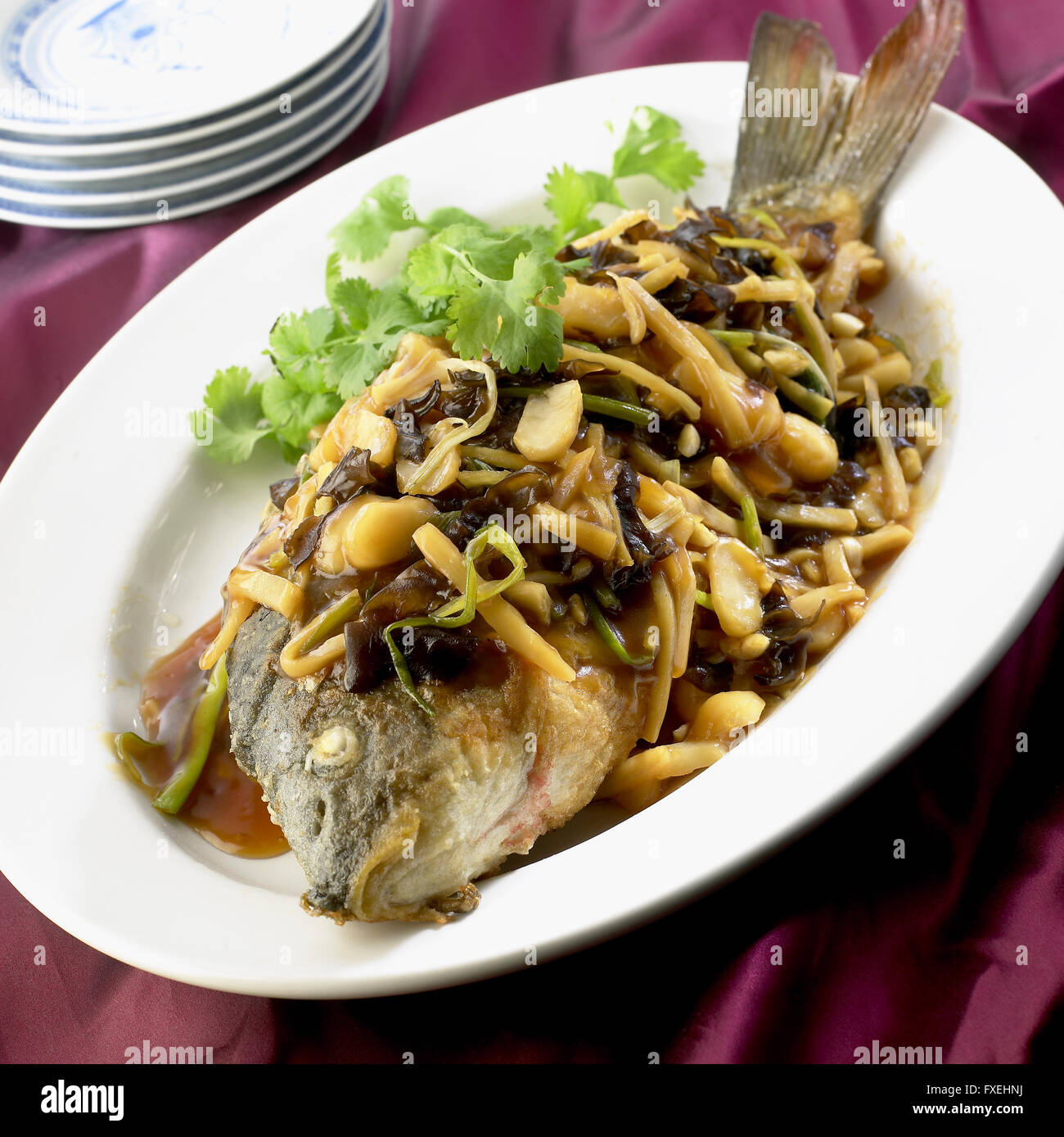 Sweet and Sour Carp, traditional Shandong dish made with Yellow River carp served on platter with vegetables and special sauce Stock Photo