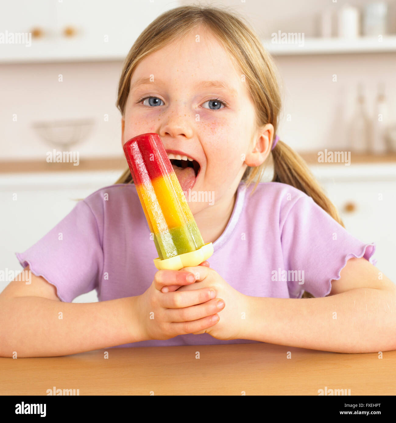 Girl licking an ice lolly Stock Photo