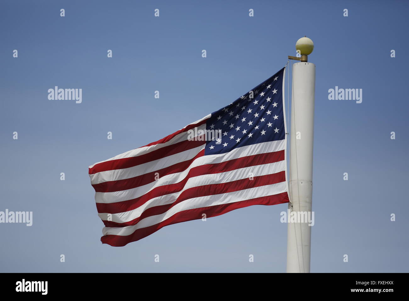 United States flag flying on cell phone tower pole at the tennis stadium on Daniel Island in Charleston, South Carolina Stock Photo