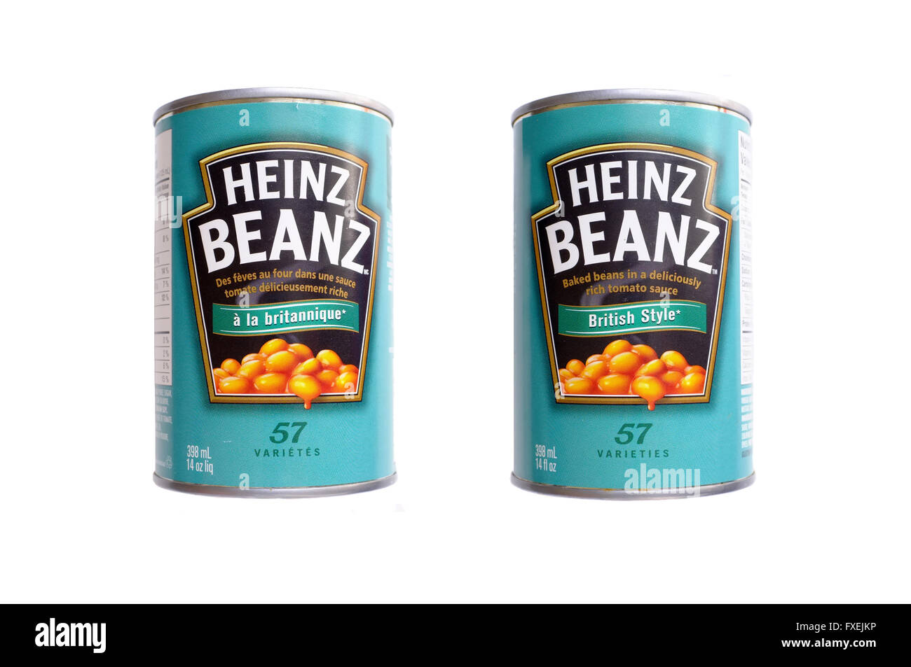 English and French labeled tins of Heinz Beanz photographed against a white background. Stock Photo