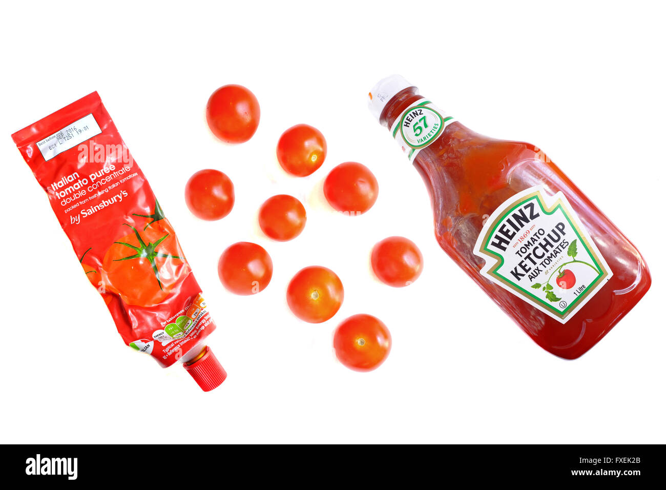 A tube of tomato puree, a bottle of tomato ketchup and cherry tomatoes