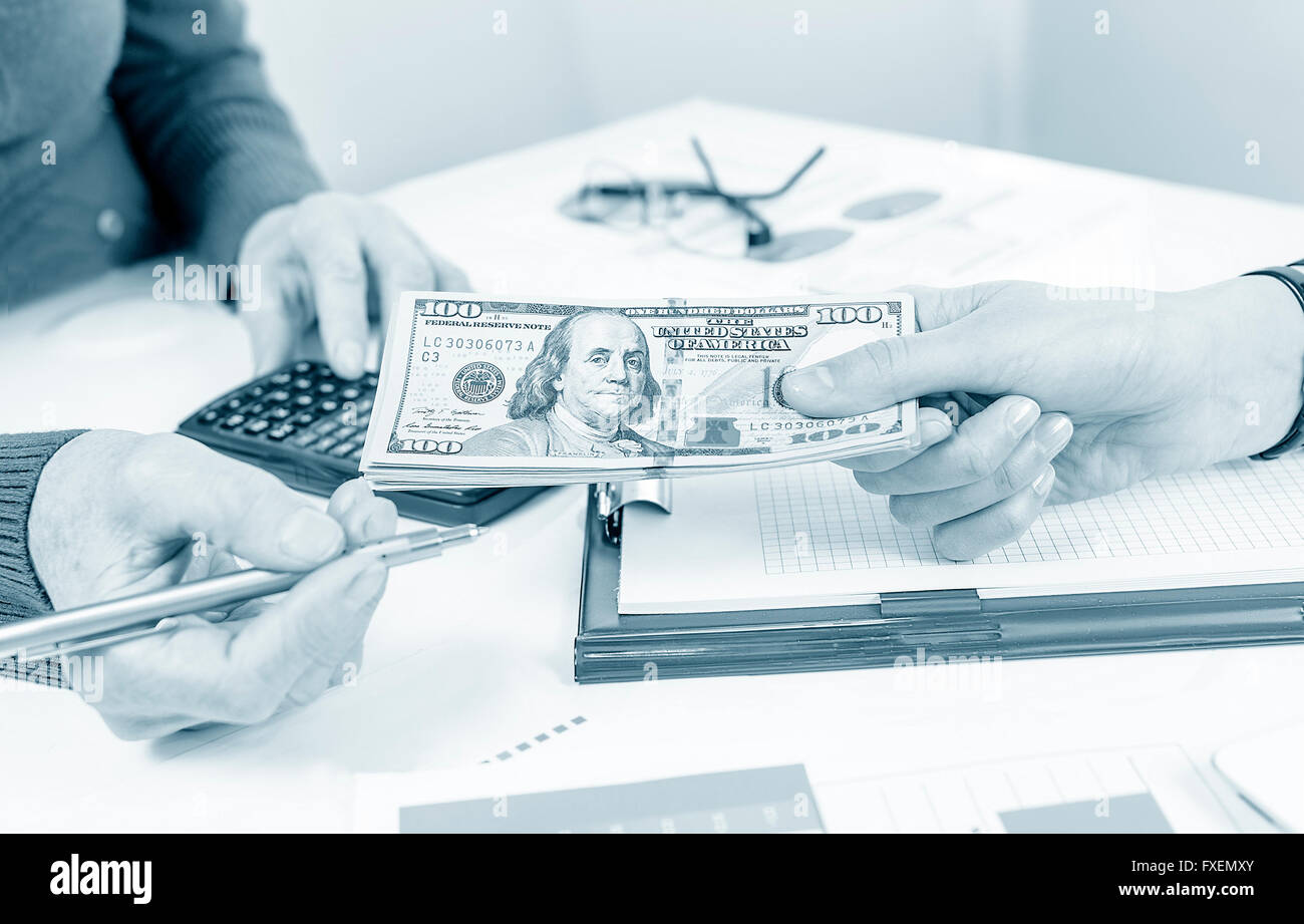 Business people exchanging dollar banknotes. Closeup shot of hands Stock Photo