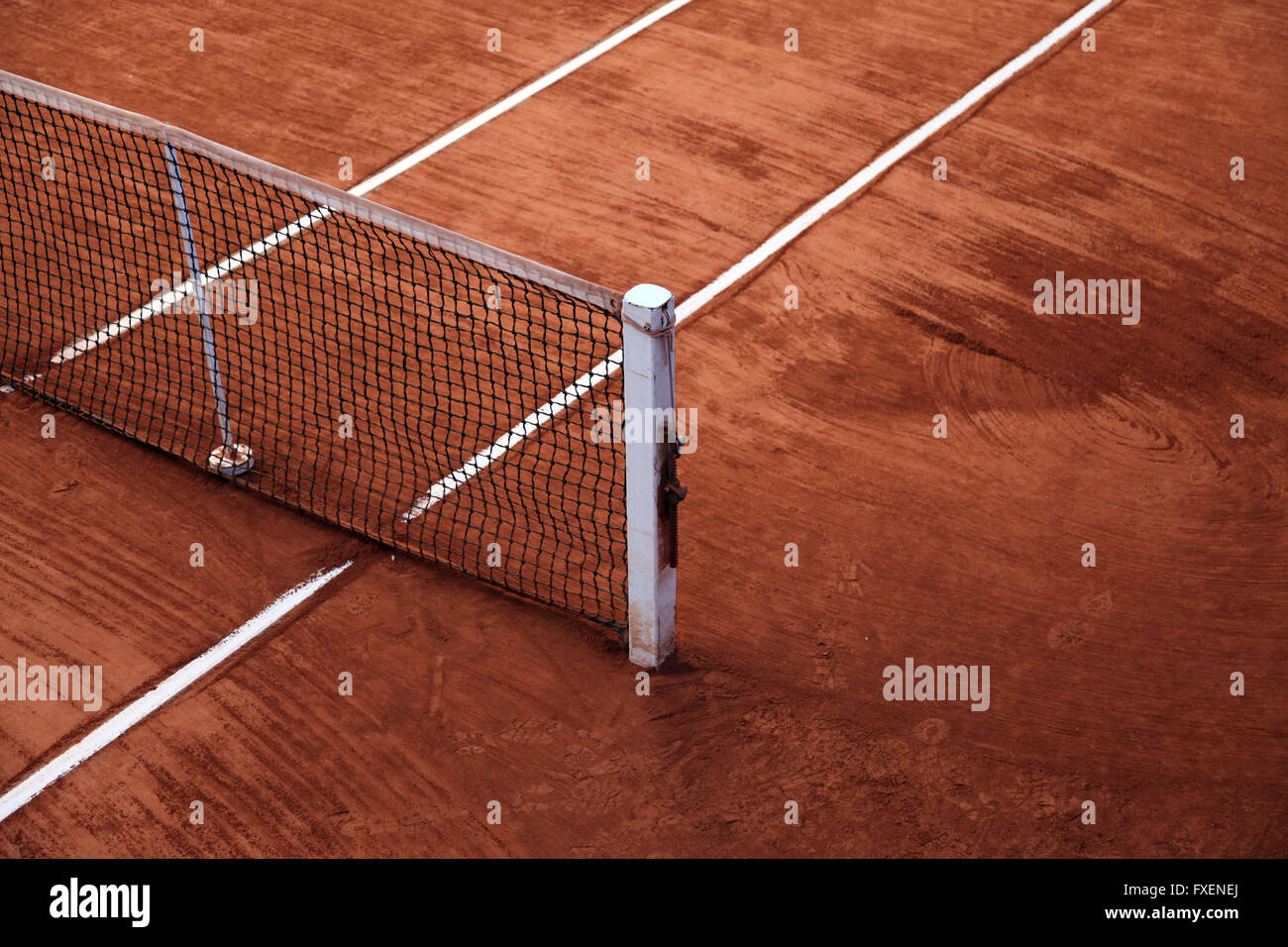 It's a photo of a detail of a tennis clay court with the white lines