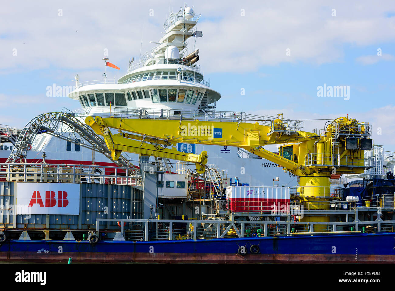 Karlskrona, Sweden - April 7, 2016: Yellow crane aboard the industrial cable transport ship Topaz Installer moored beside the AB Stock Photo