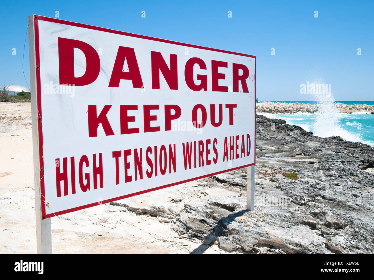 The warning sign on Grand Bahama Island rocky beach Stock Photo Alamy