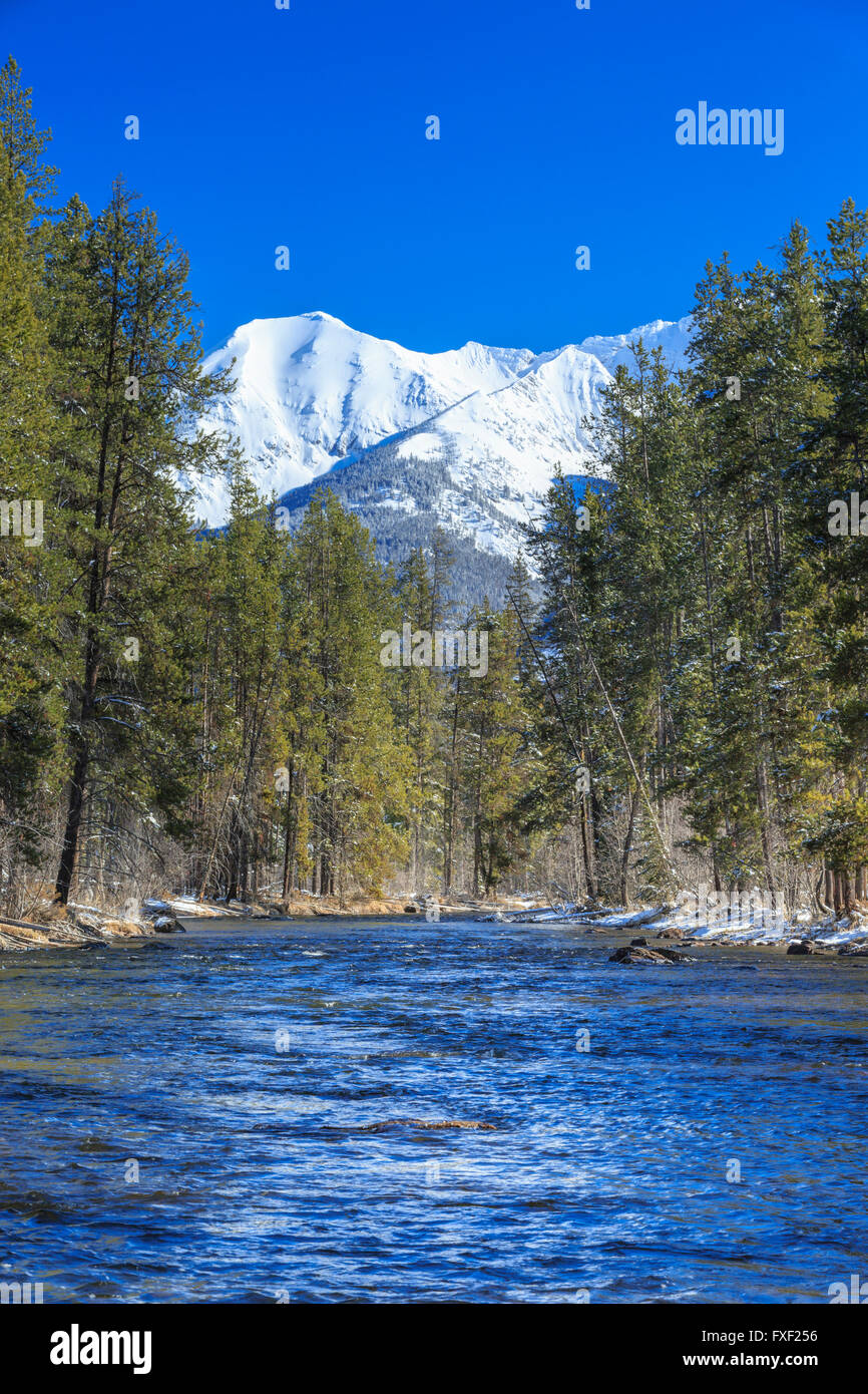 swan river below peaks of the swan range in winter near condon, montana