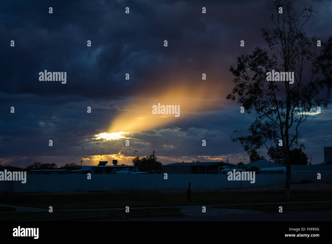 The Sun looking trough the clouds after a storm. Bedourie, Queensland, Australia Stock Photo