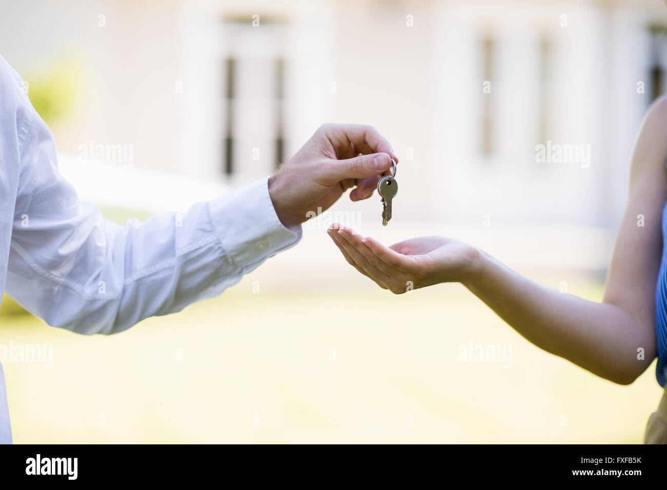 Real estate agent giving keys to woman Stock Photo