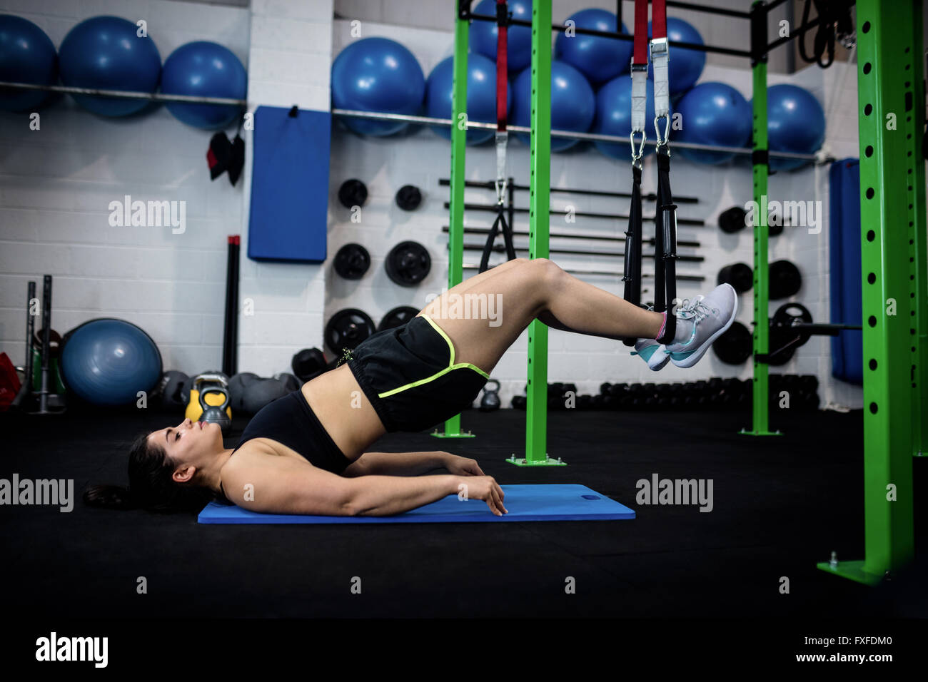 Woman doing suspension training with trx fitness straps Stock Photo - Alamy