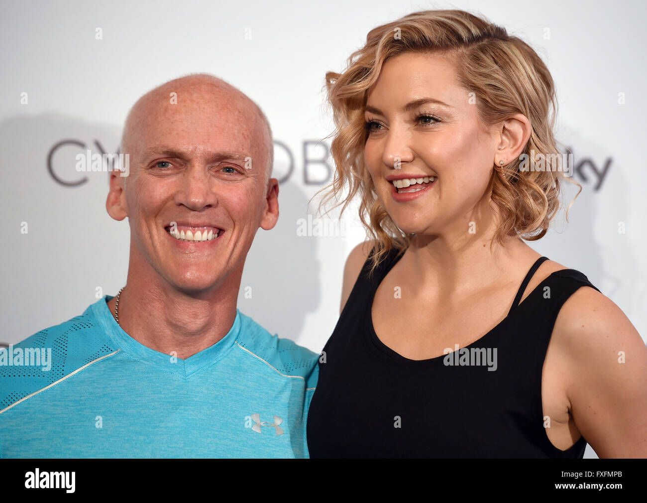 Berlin, Germany. 14th Apr, 2016. US actor Kate Hudson and US fitness coach David Kirsch pose at the fitness studio 'World of Cyberobics' in Berlin, Germany, 14 April 2016. The fitness arena will open on 18 April 2016. Photo: Britta Pedersen/dpa/Alamy Live News Stock Photo