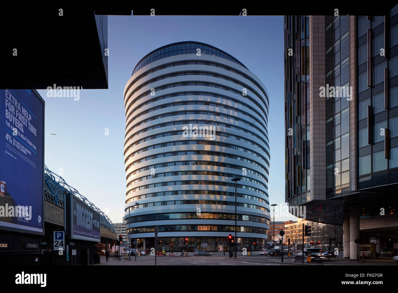 Square view at dawn from street. Westminster Bridge Road, London, United Kingdom. Architect: AHMM , 2015. Stock Photo
