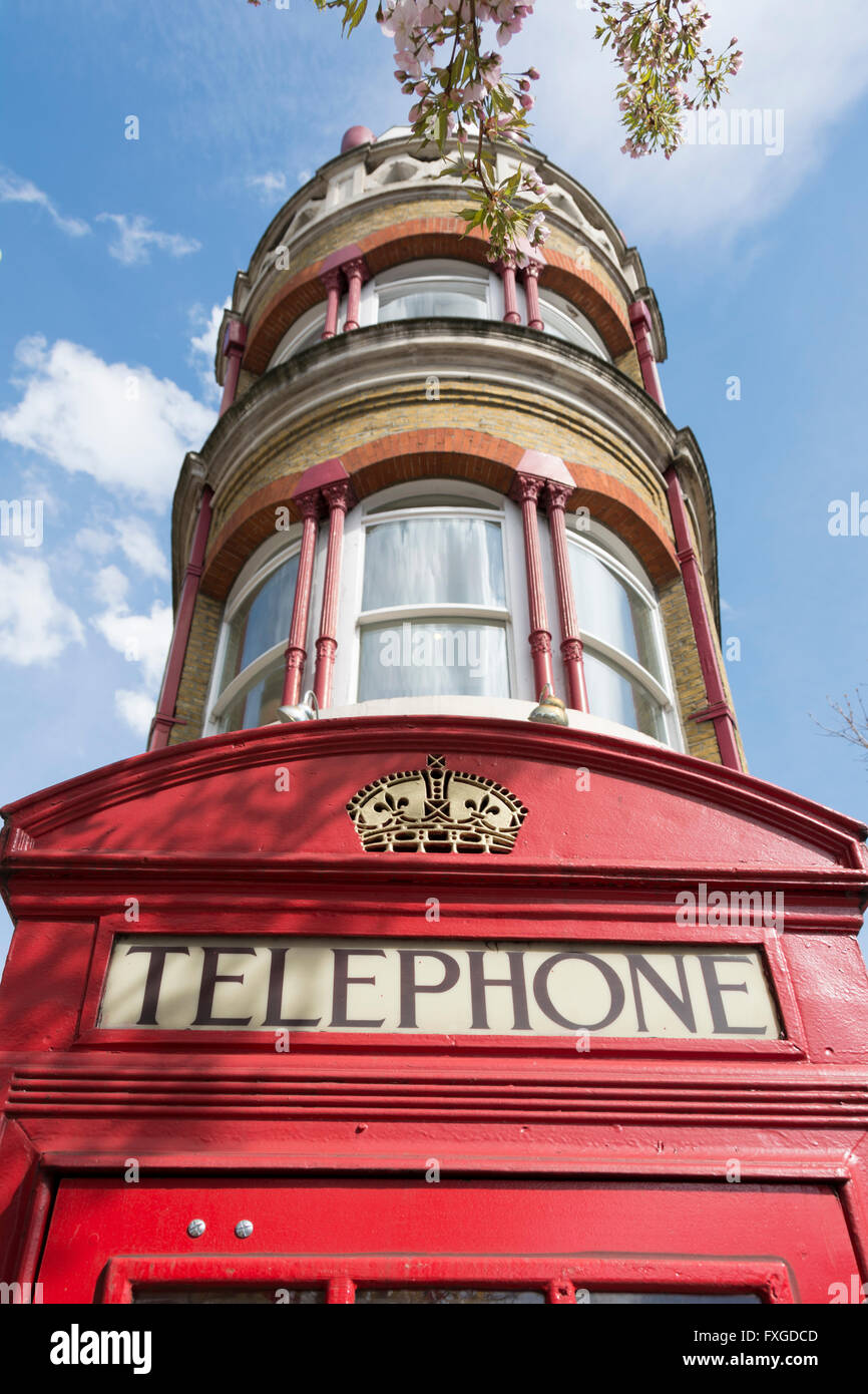 One of London's red telephone boxes, or kiosks, designed by Sir Giles Gilbert Scott, Stock Photo