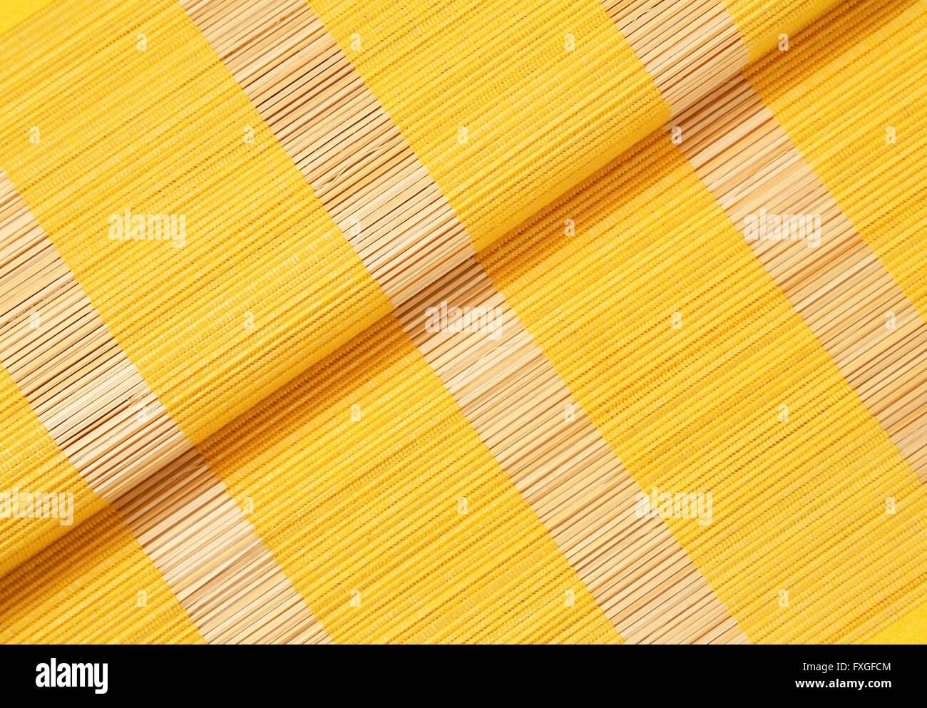 Detail of yellow bamboo place mat Stock Photo