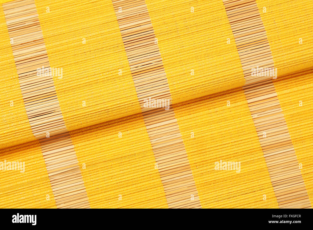 Detail of yellow bamboo place mat Stock Photo
