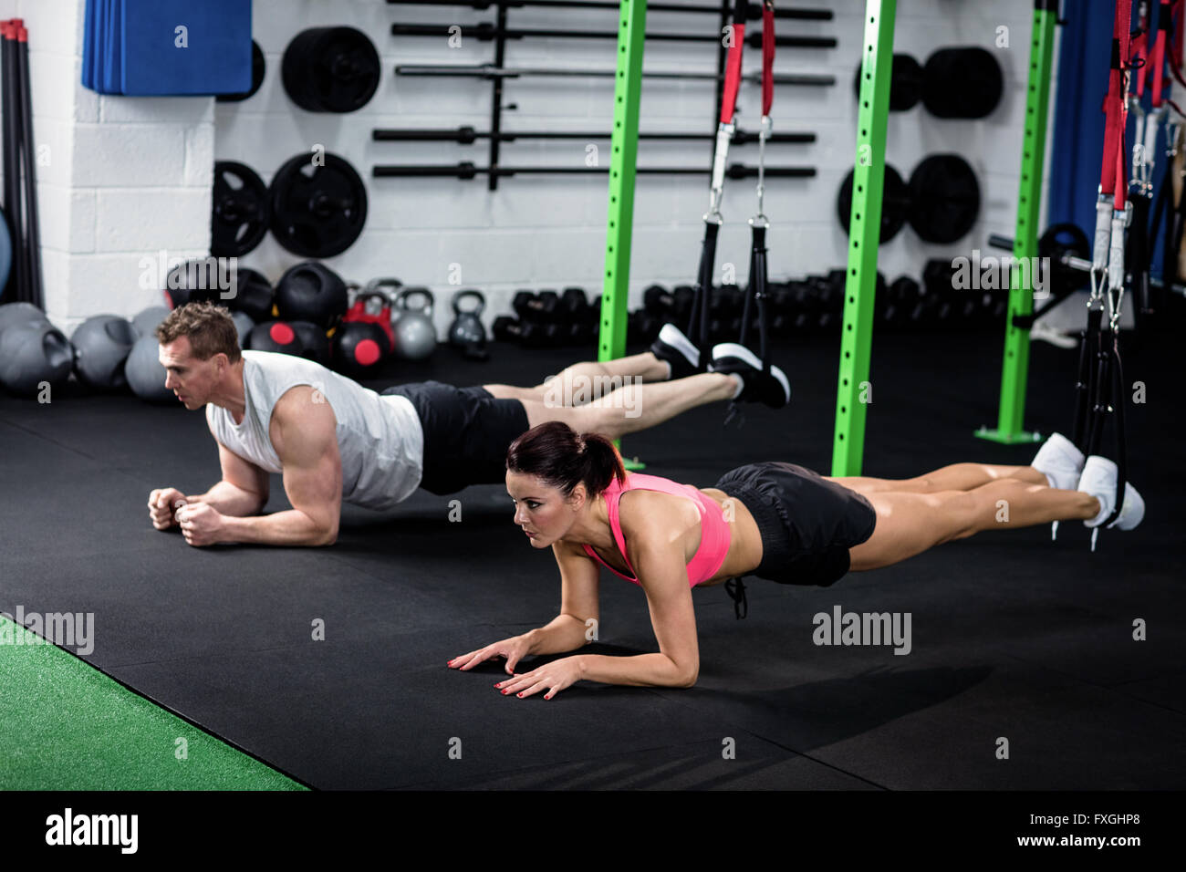 Man and woman doing suspension training with trx fitness straps Stock ...