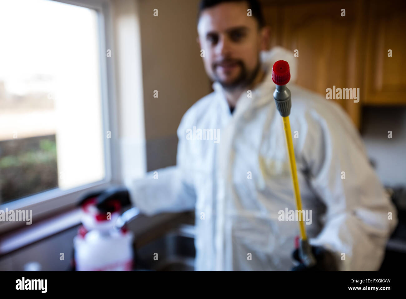 Pest control man spraying pesticide Stock Photo Alamy