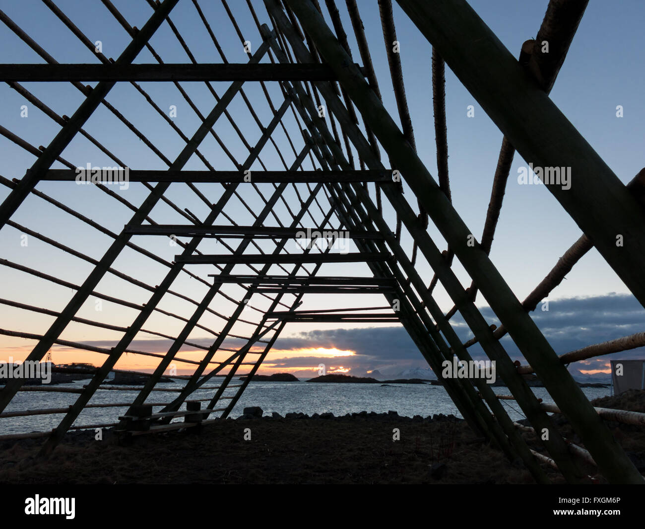 Silhouette of rack for drying stockfish at sunset, near Henningsvaer on Lofoten Islands, Norway Stock Photo