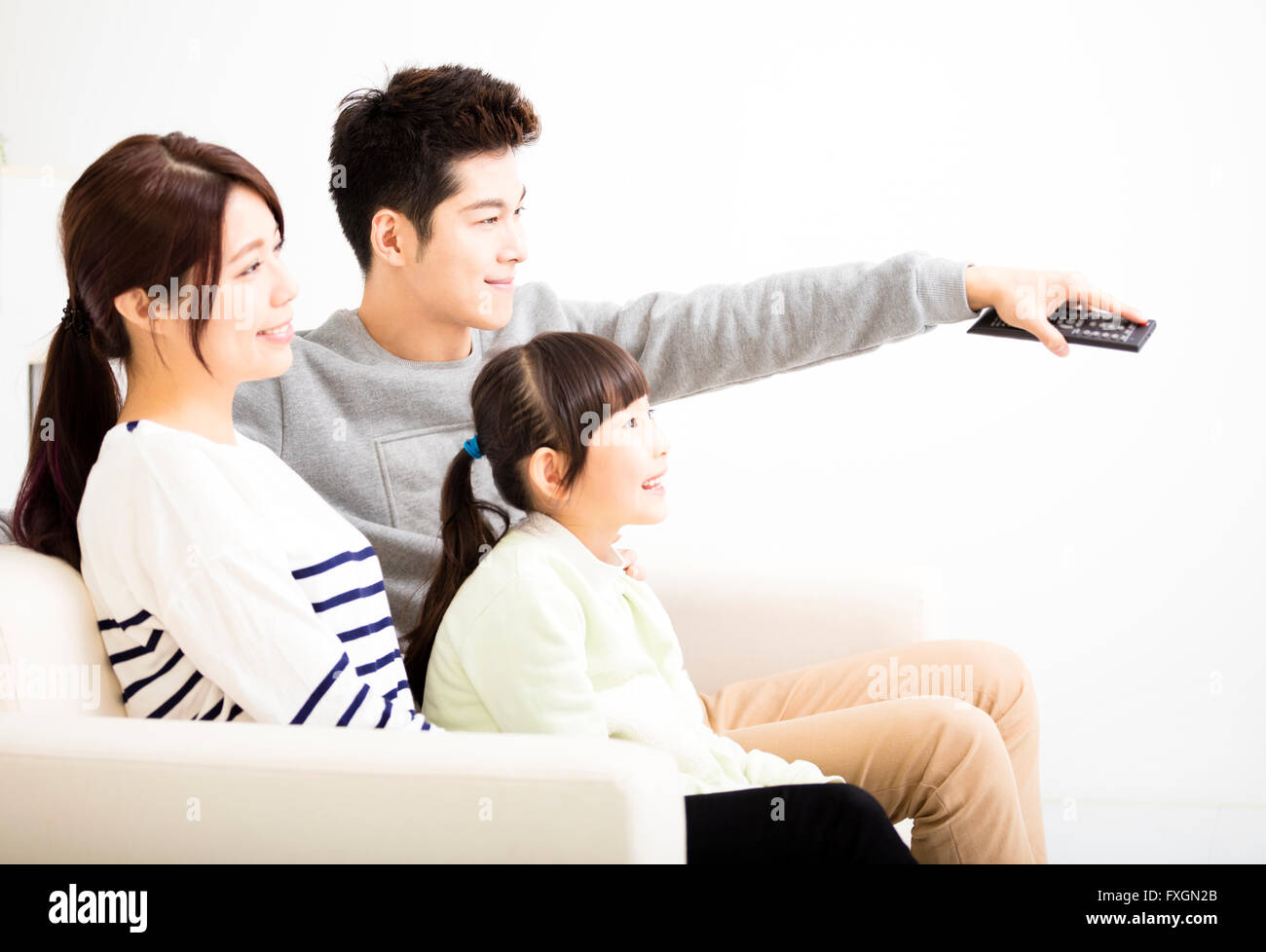 Happy Attractive Young  Family watching the tv Stock Photo