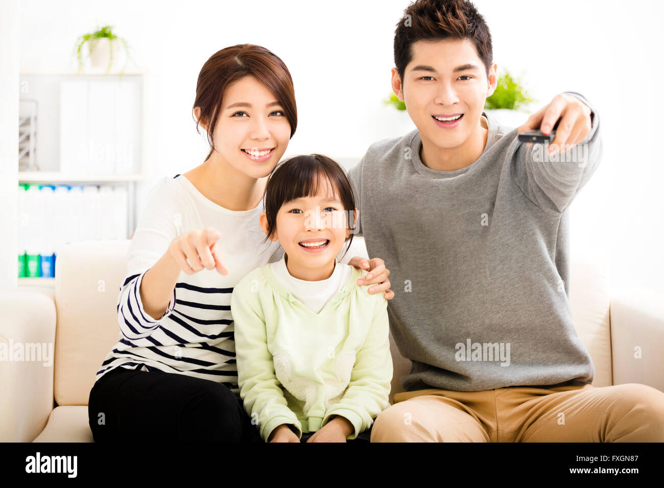 Happy Attractive Young  Family watching the tv Stock Photo