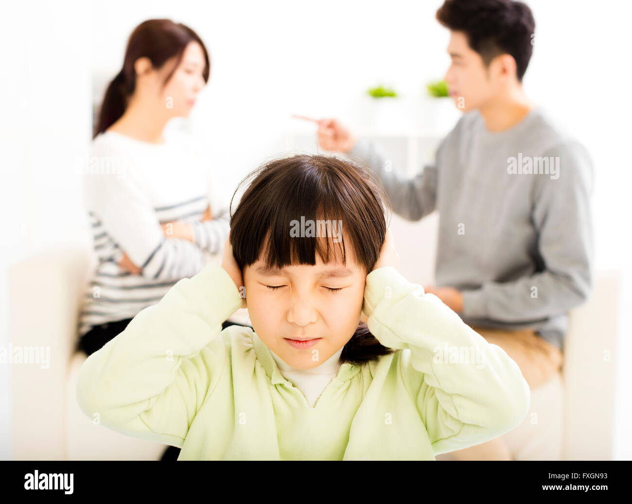 Parents fighting and little girl being upset Stock Photo