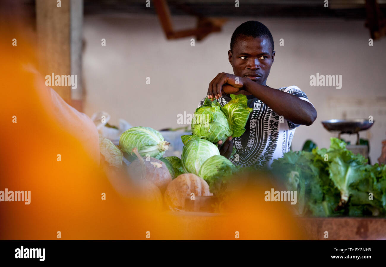 Mozambique, a man selling vegetables at the market in the city. Stock Photo