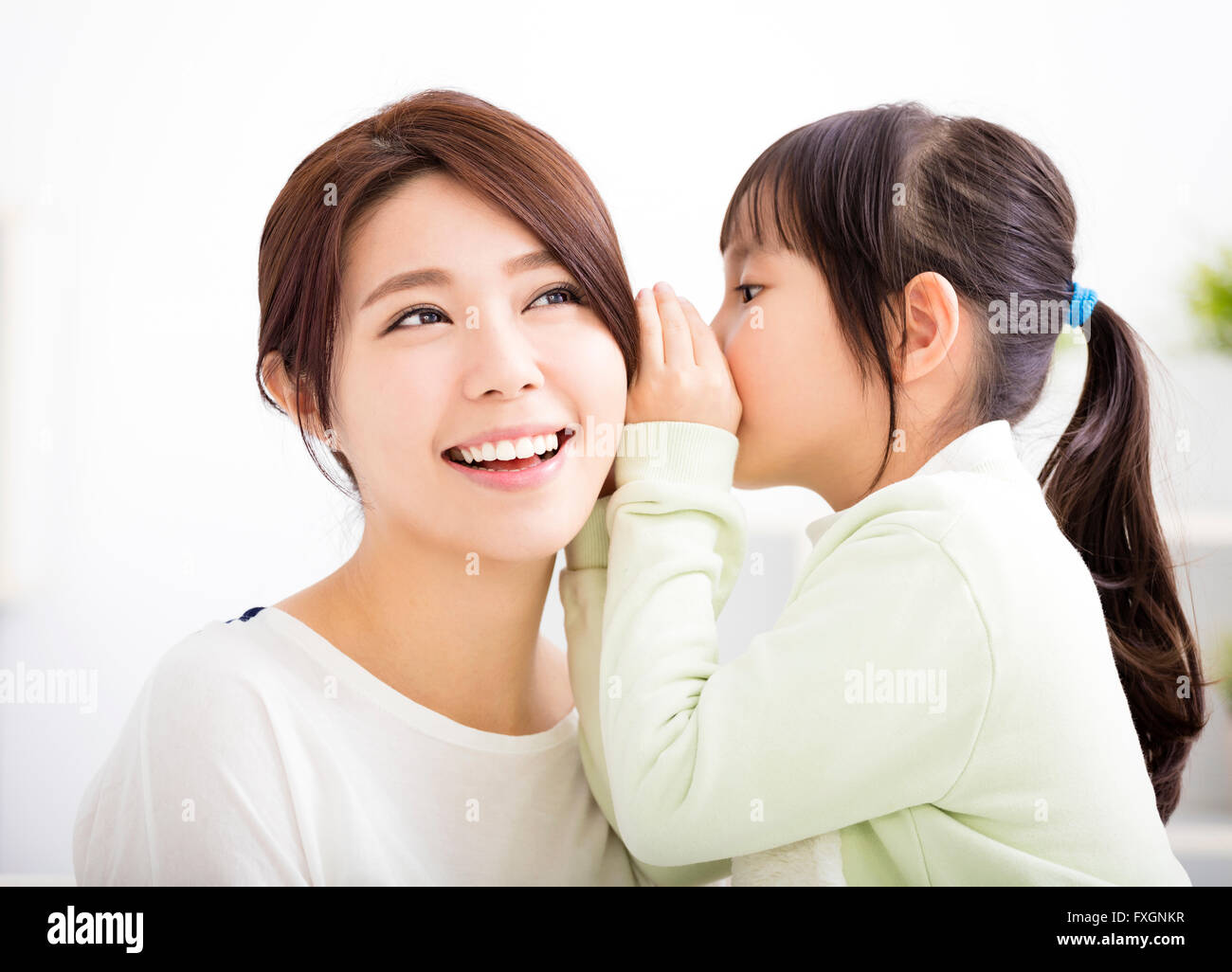 mother and daughter whispering gossip Stock Photo