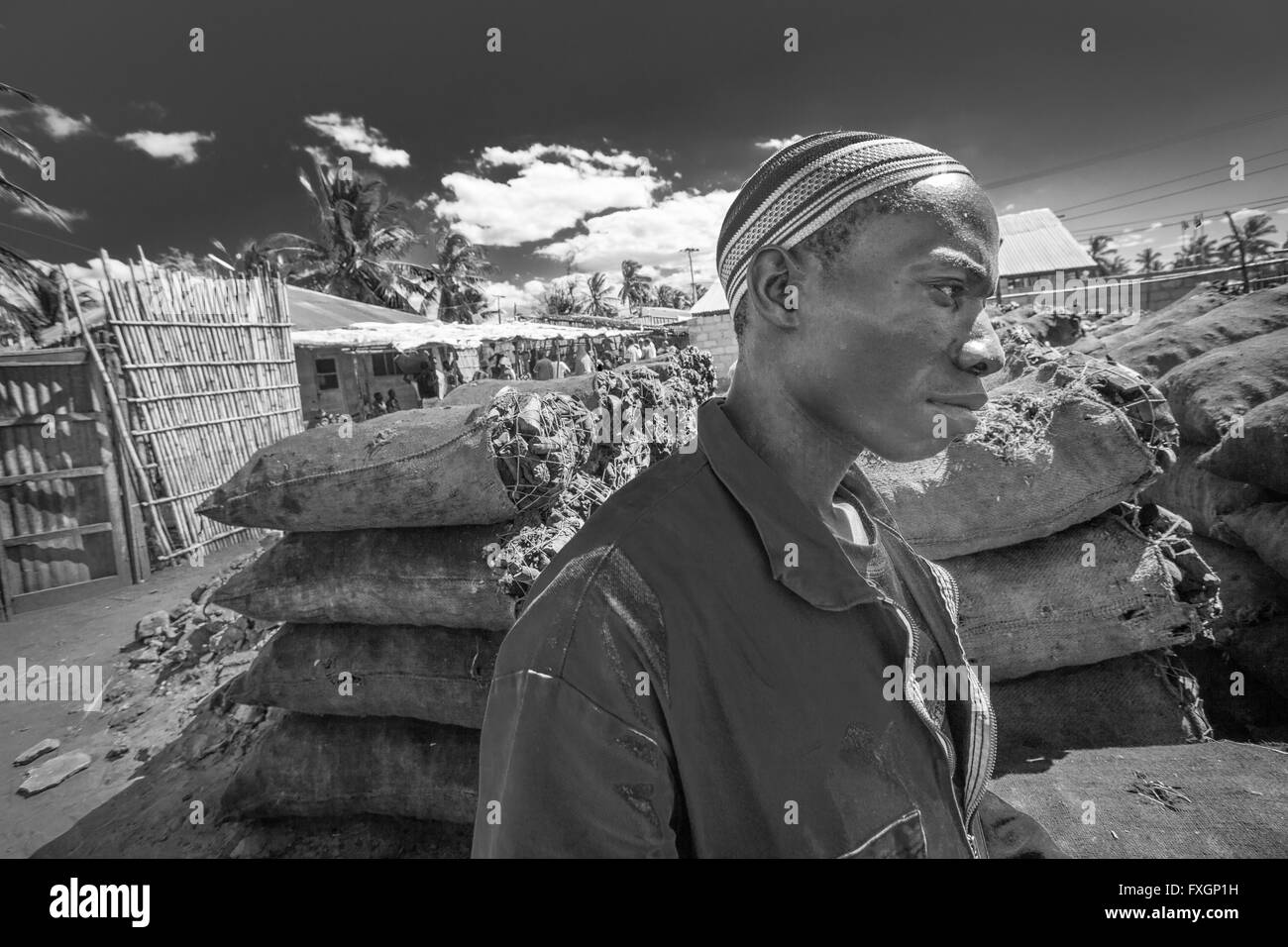 mozambique, africa, a young man selling coal at market in Pemba, also available in colour Stock Photo